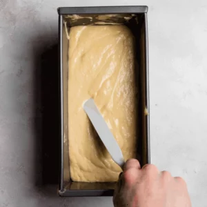 Pour the batter into the prepared loaf pan and level with an offset spatula