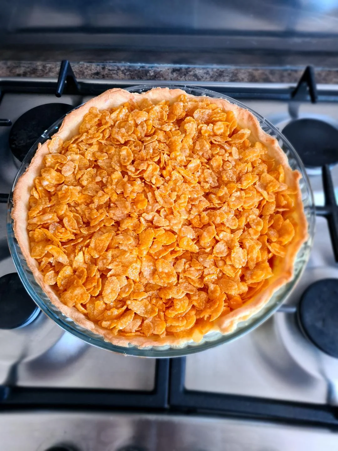 Whole cornflake tart with raspberry jam and toasted cornflakes, fresh from the oven