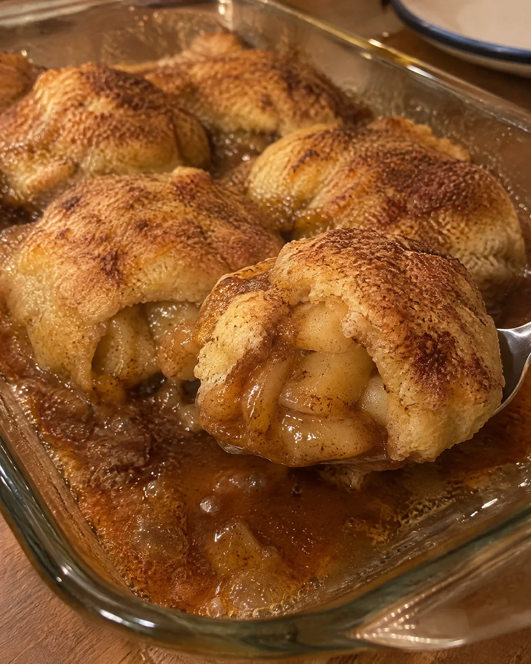 Baked apple dumplings in a bubbling butter and cinnamon sauce