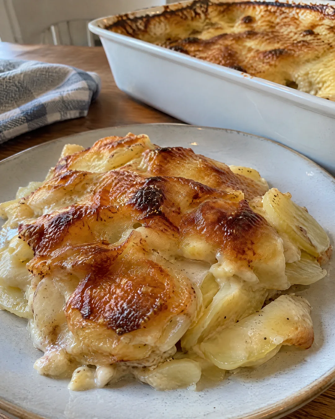Serving of au gratin potatoes with crisp cheese top