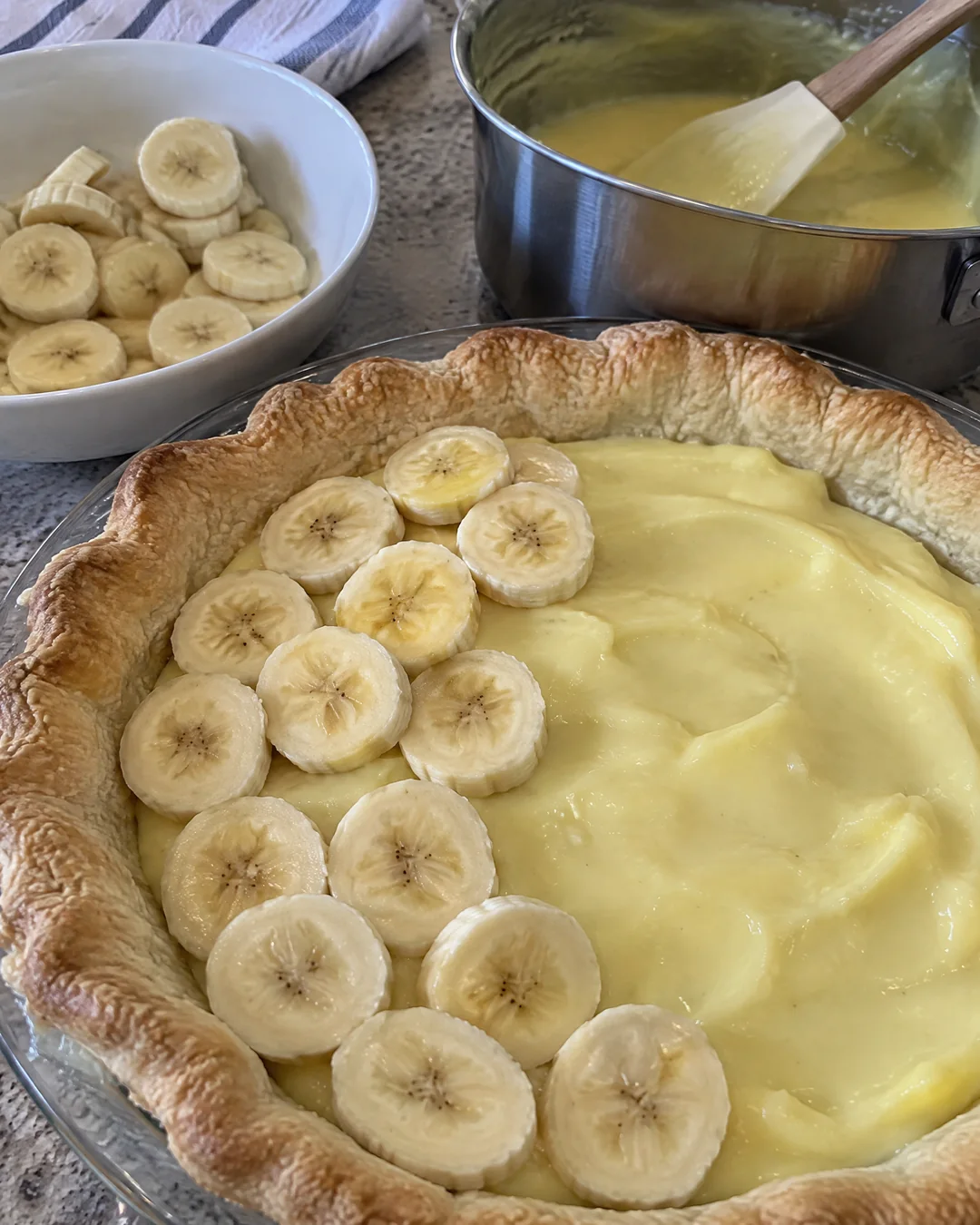 Banana slices laid over the first layer of custard