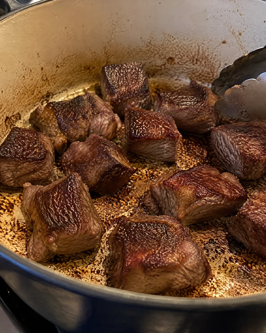 Cubes of beef browning in a heavy pot