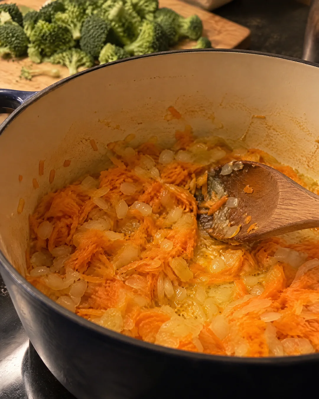 Onion and carrot softening in butter in a soup pot