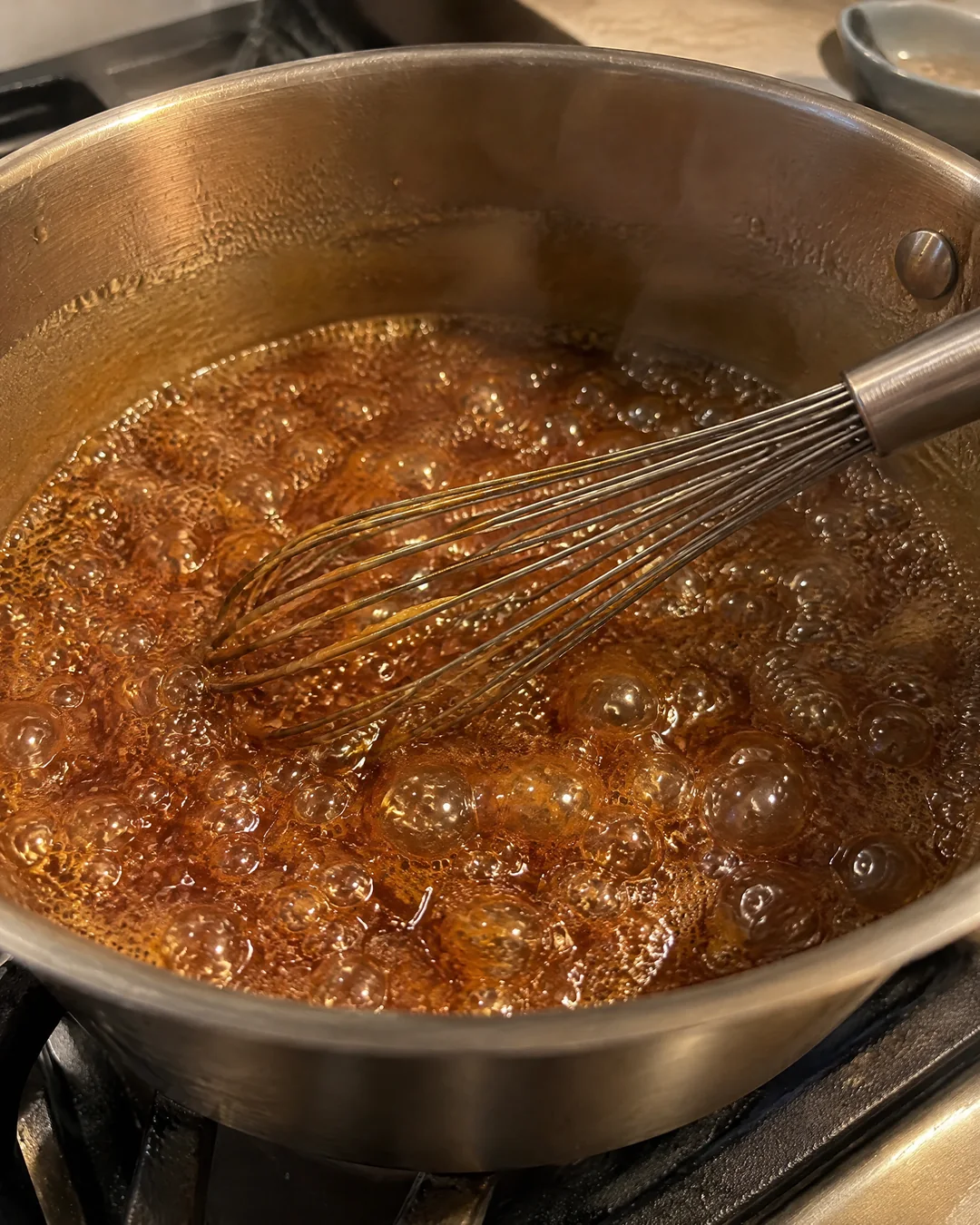 Brown sugar and butter cooking into butterscotch in a heavy pan