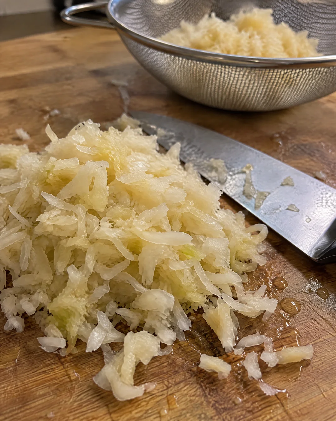Rinsed sauerkraut squeezed dry and chopped fine on a cutting board