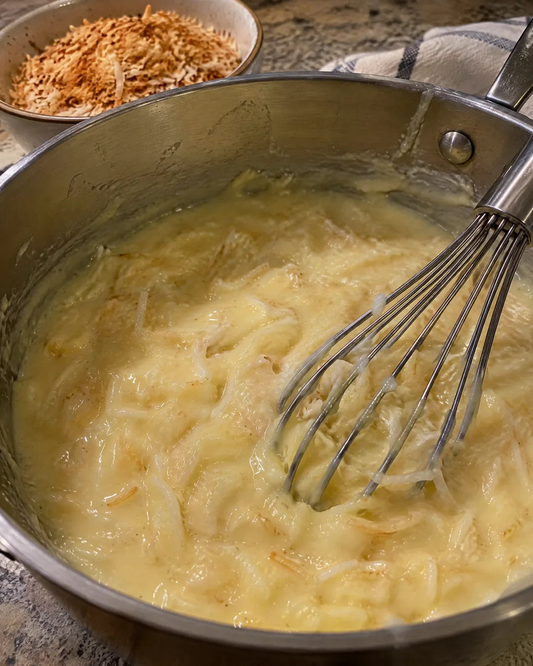 Thick coconut custard cooking in a saucepan