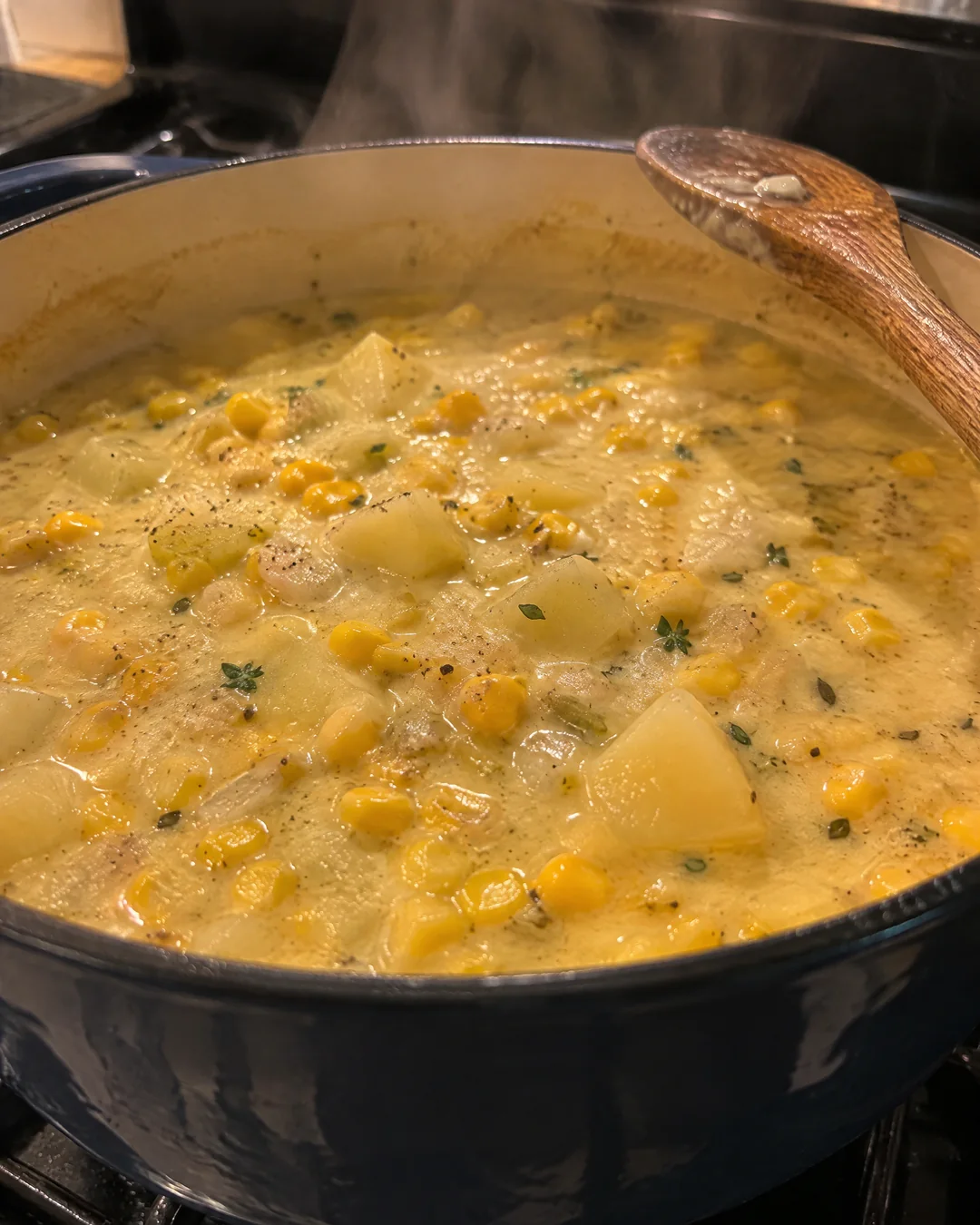 A pot of corn chowder simmering on the stove