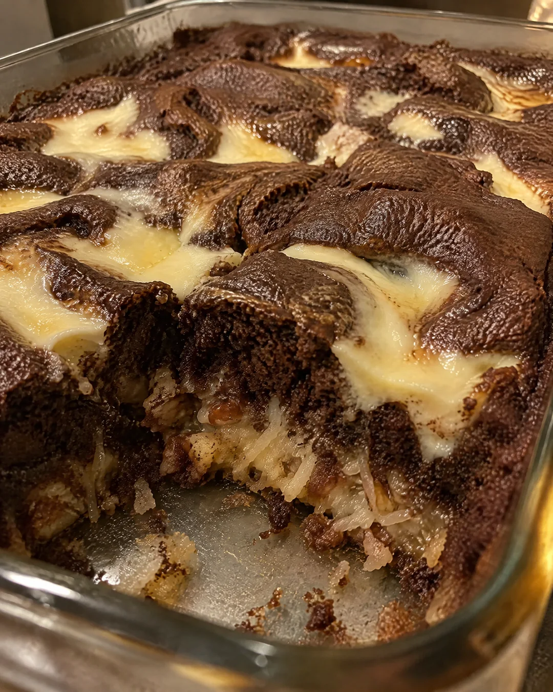 Baked earthquake cake cracked open with cream cheese pockets