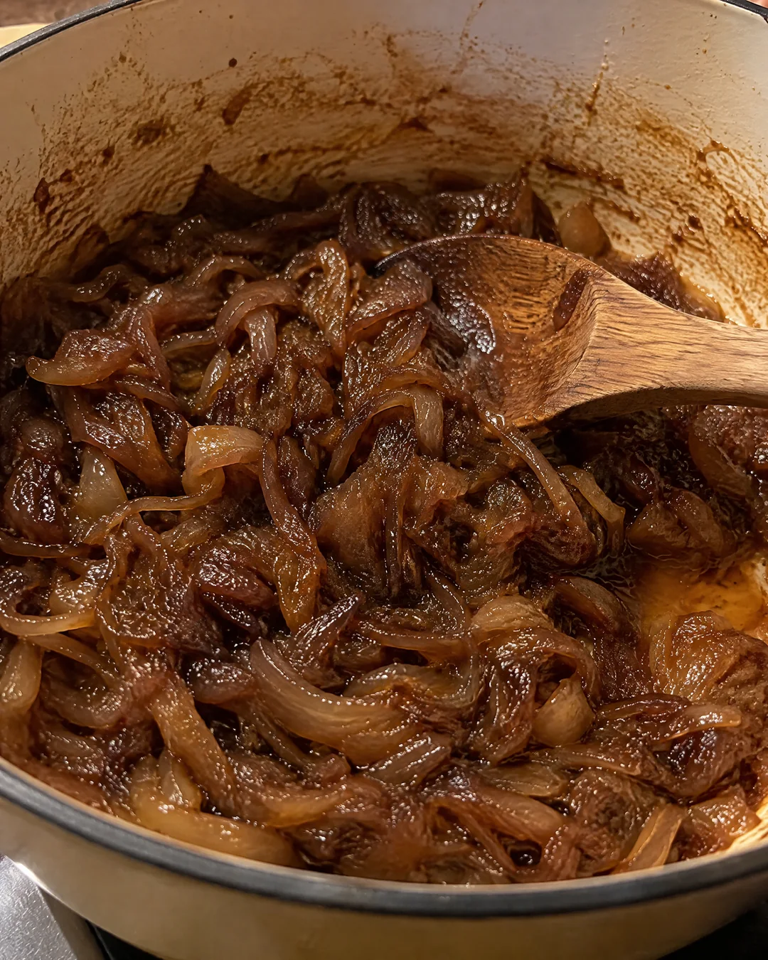 Deep brown caramelized onions in a heavy pot