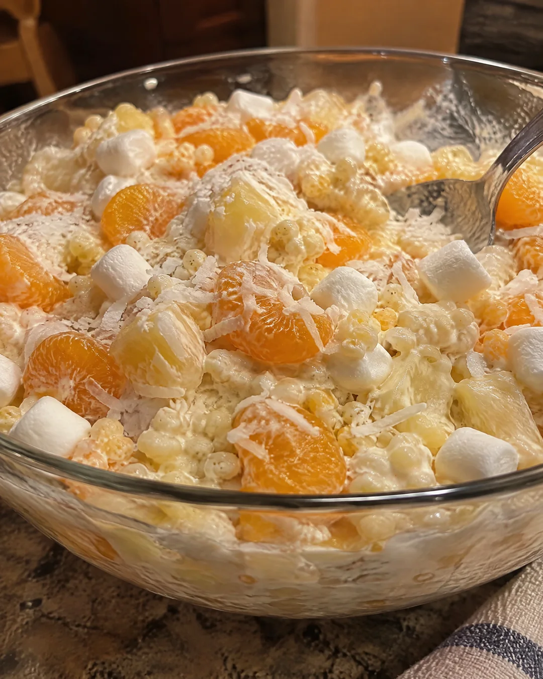 A bowl of frog eye salad with mandarin oranges, pineapple and marshmallows