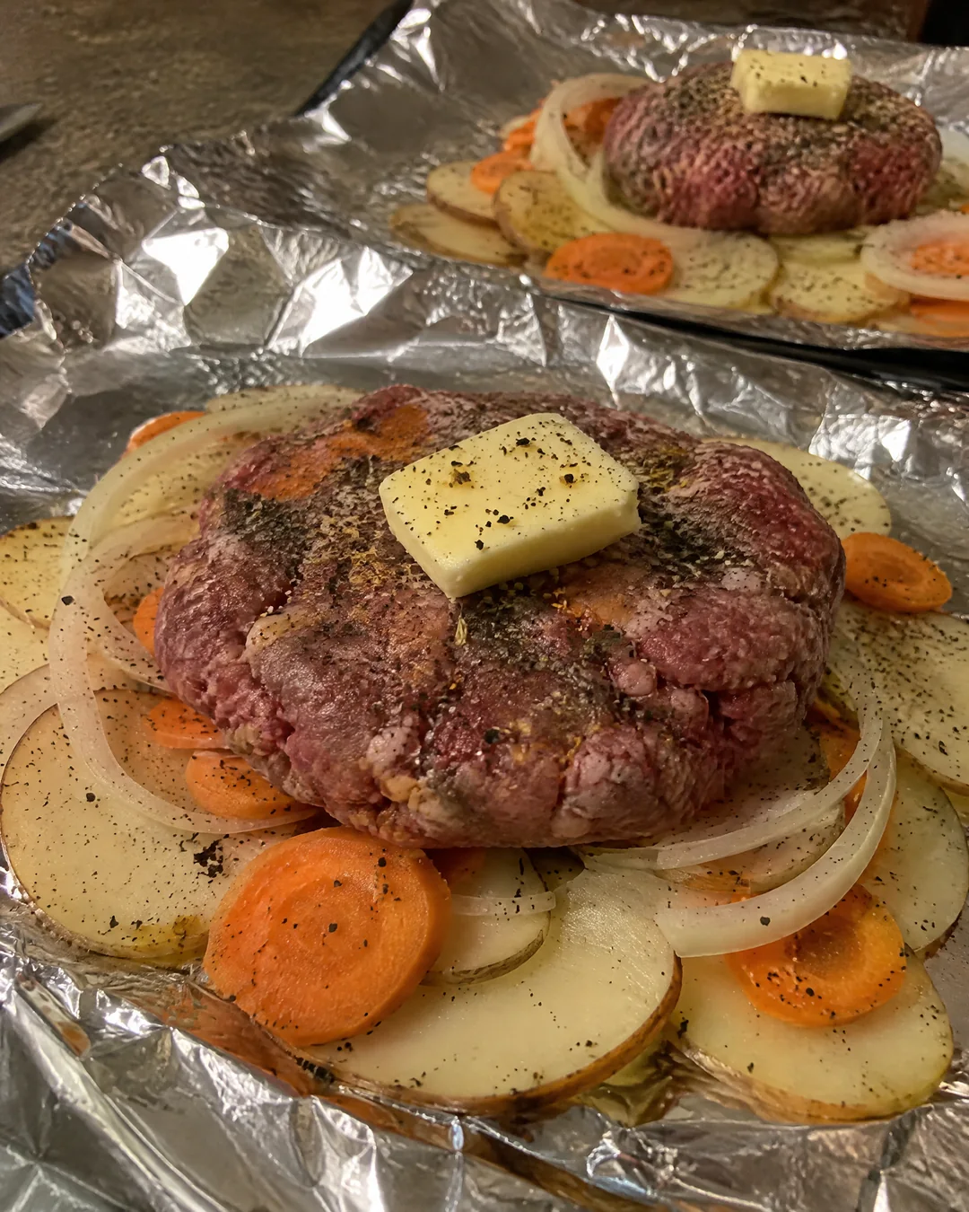 Assembling foil packet hamburger dinners
