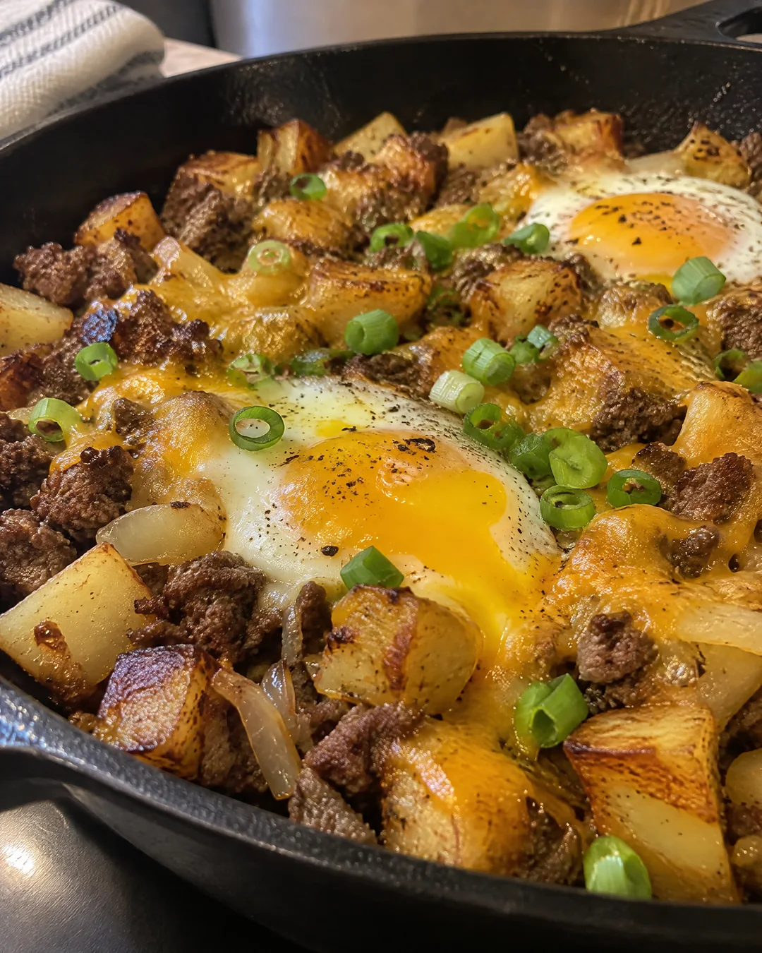 Hamburger hash with melted cheddar and fried eggs