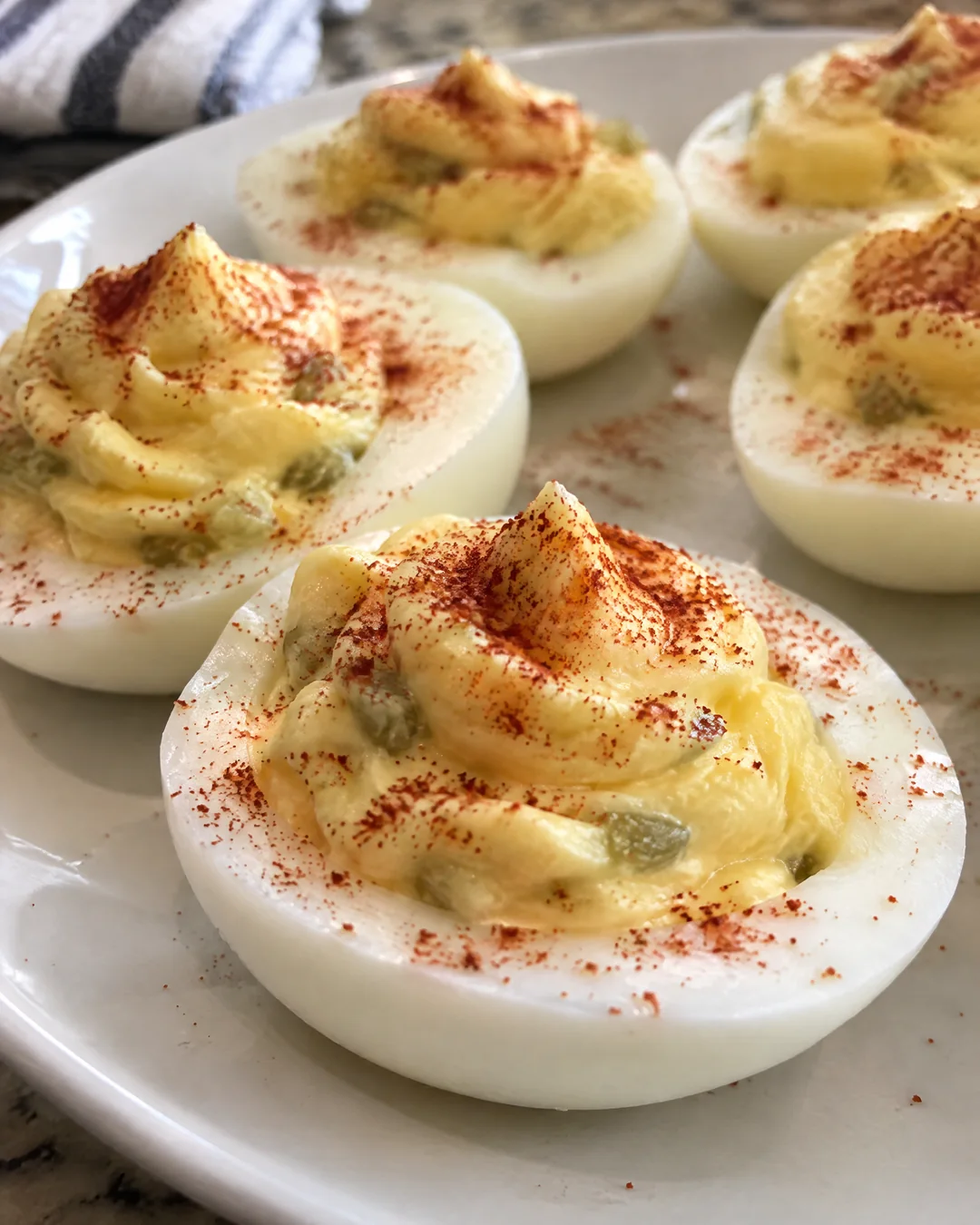 Deviled eggs dusted with paprika on a plate