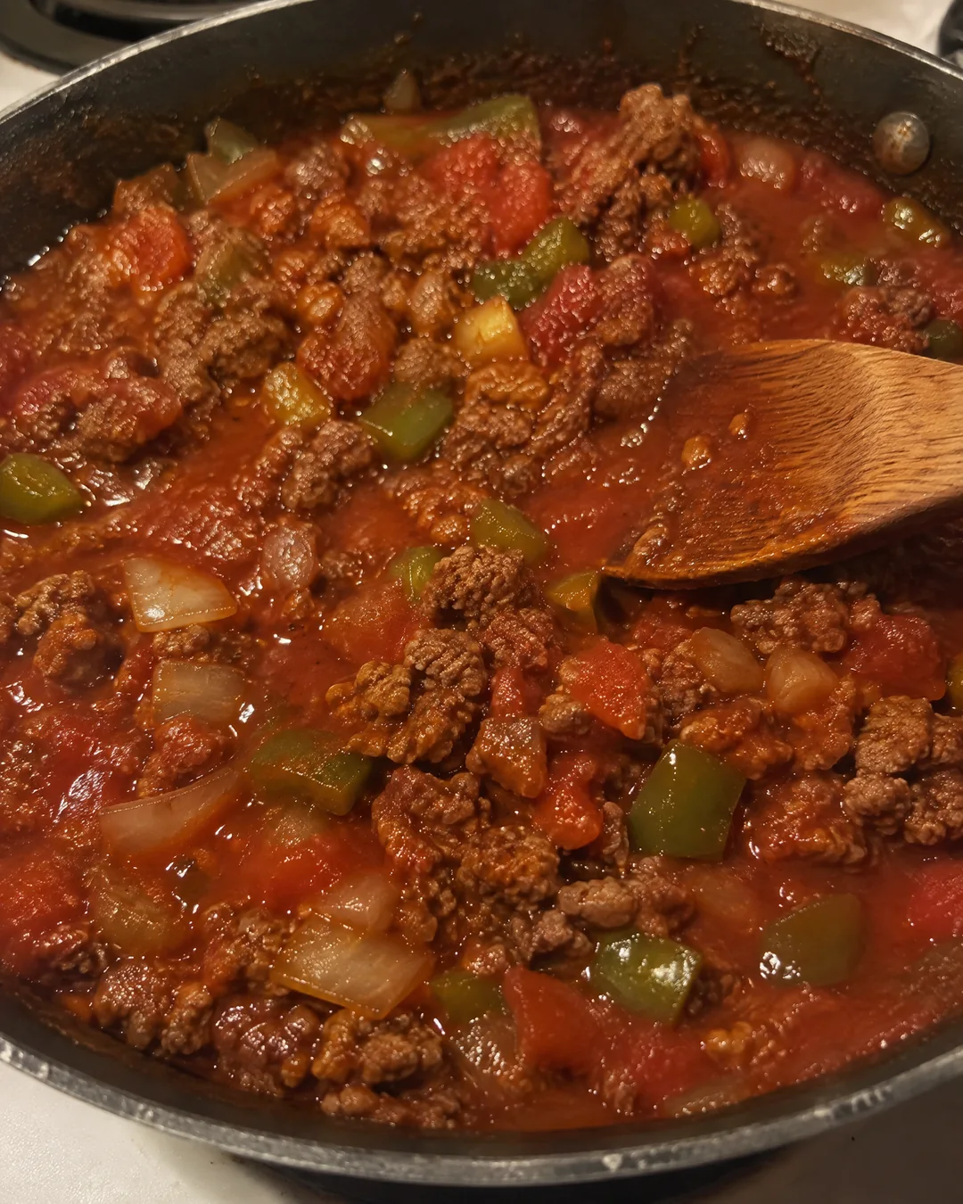 Ground beef simmering in a sweet tomato sauce for sloppy joes