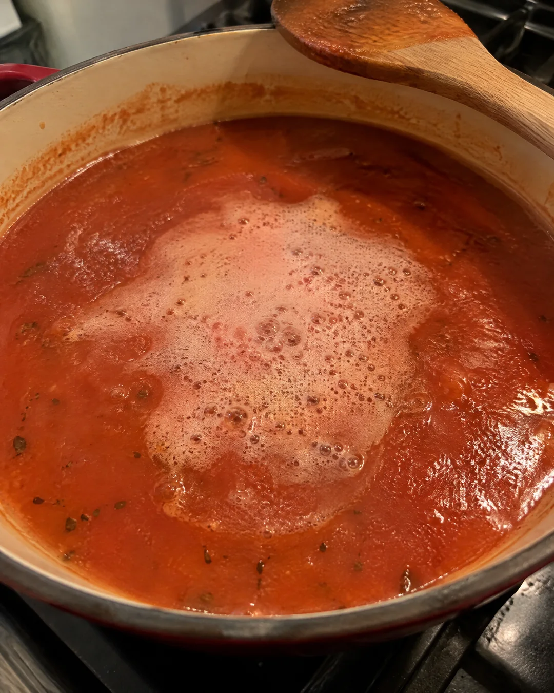 Baking soda foaming in a pot of tomato soup