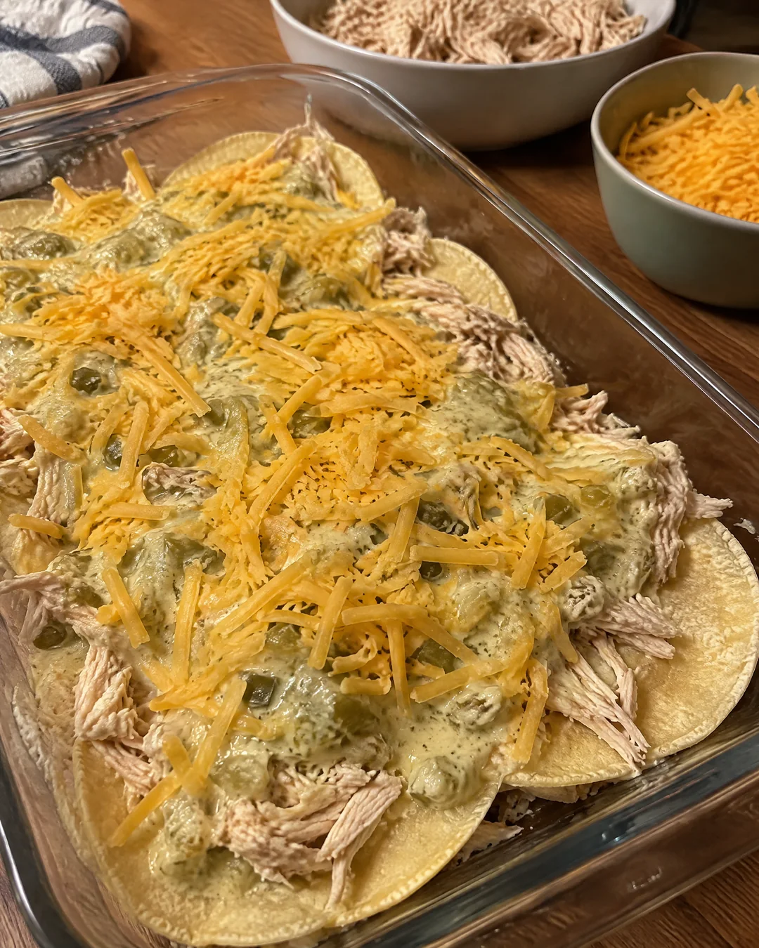 King Ranch chicken casserole being layered in a baking dish