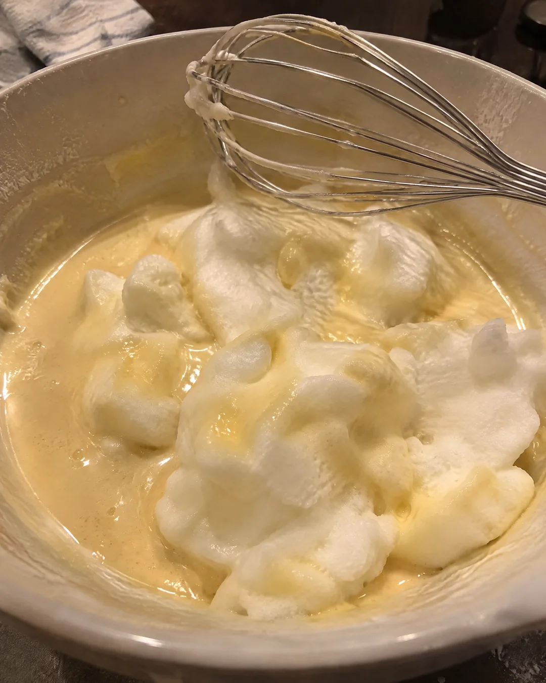 Thin magic cake batter with clouds of egg white floating on top