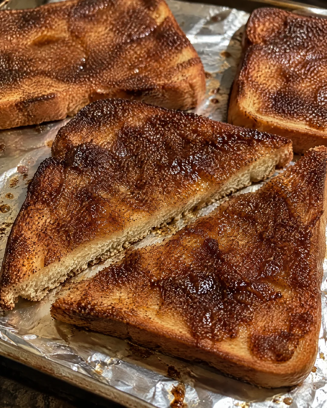 Cinnamon toast fresh from the broiler, caramelized and crackled on a sheet pan