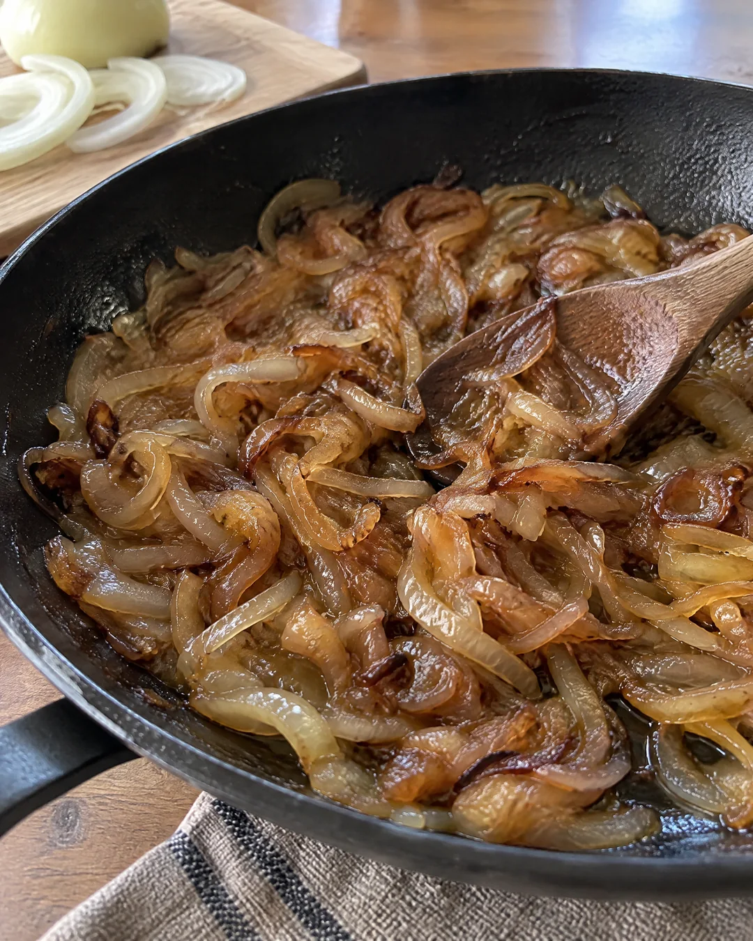 Onions caramelizing slowly in butter in a skillet for patty melts