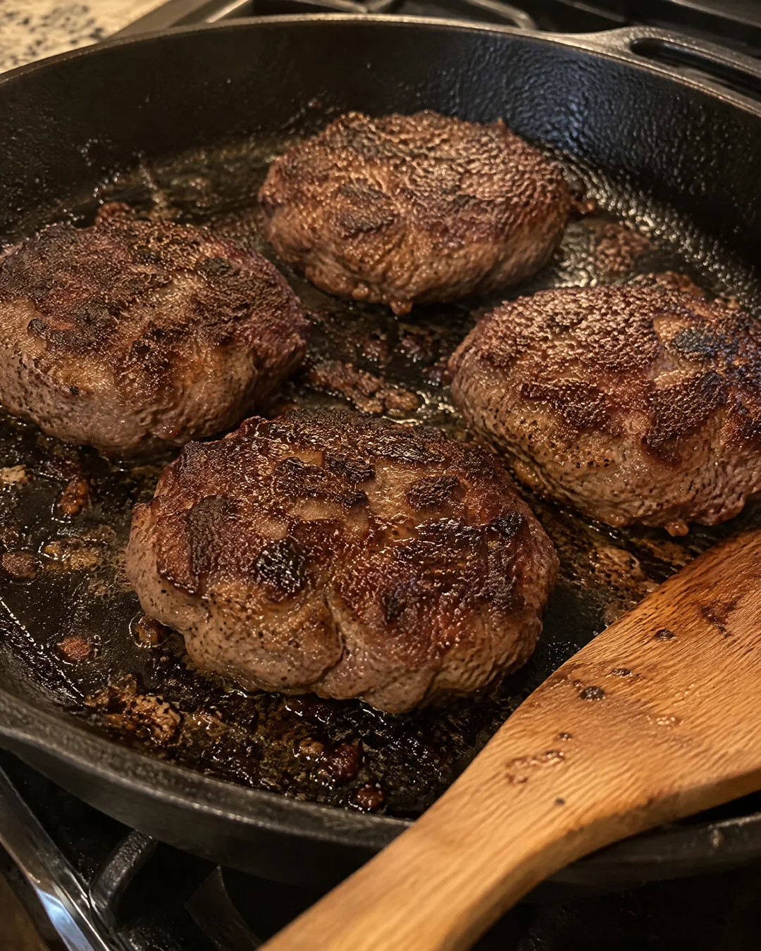Browned Salisbury steak patties in a skillet