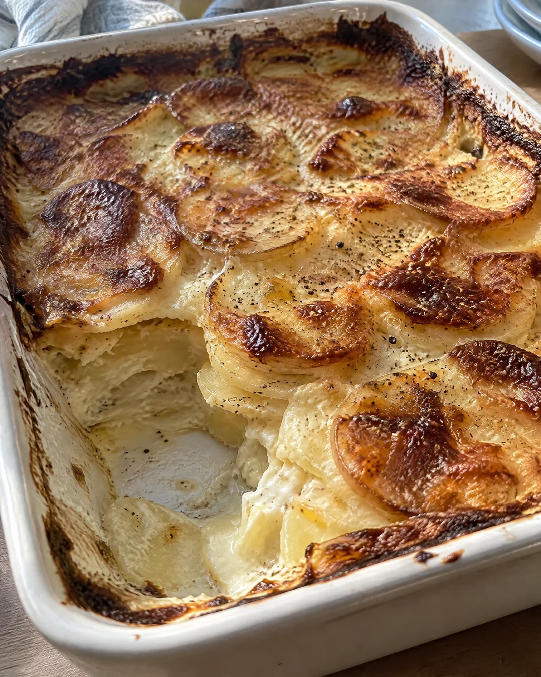 Golden scalloped potatoes with bubbling brown edges