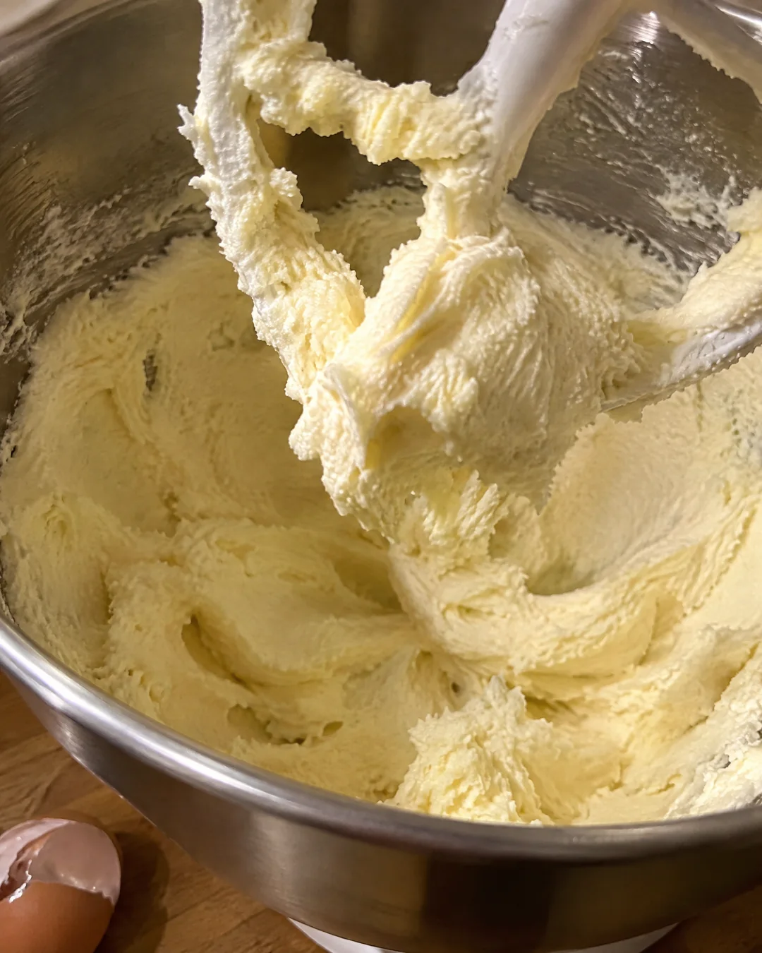 Creamed butter and sugar in a mixing bowl, pale and fluffy after seven minutes of beating