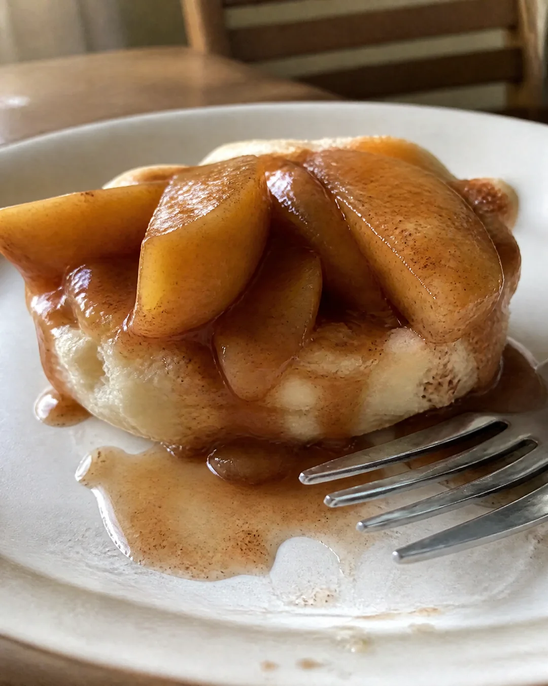 Fried apples in a dark cinnamon syrup spooned over a split buttermilk biscuit