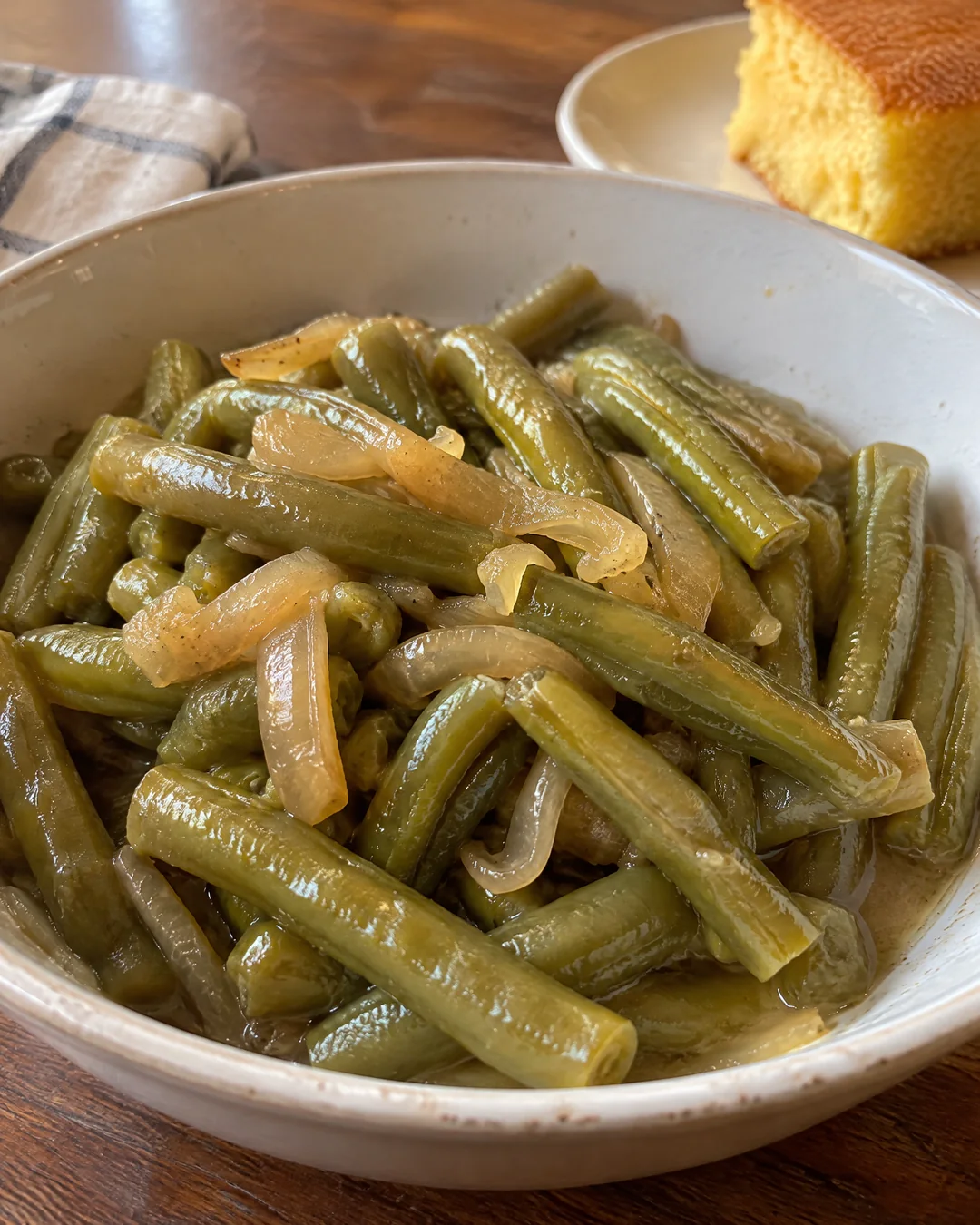 A bowl of soft Southern green beans cooked down with butter and onion